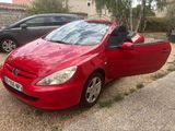 a red car that is parked next to a black car