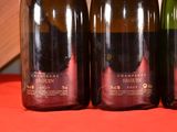 three bottles of wine are lined up on a table