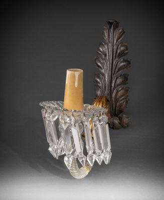 pair of crystal wall sconces in the shape of a candle holder