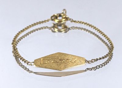 gold plated bracelet with a gold plated arrow charm on a chain