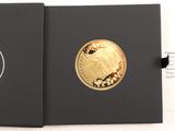 a close up of a black box with a gold coin in it