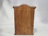 a small wooden cabinet with a mirror on top of it