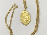 a gold plated necklace with an om sign on it
