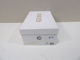 a white box with gold lettering on it on a table