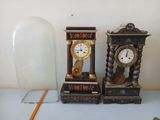 two clocks that are sitting next to each other on a table