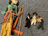 a doll that is laying on the ground next to other dolls