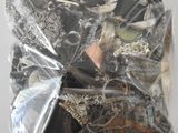 a bag full of assorted jewelry on a table