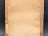 an old photo of a piece of brown paper on a black background
