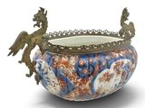 a decorative bowl with a bird on it on a white background