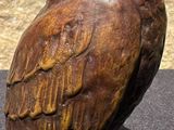 a statue of an owl that is sitting on a table