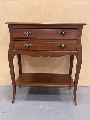 a small wooden table with two drawers on top of it
