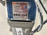 a close up of a parking meter with a sticker on it