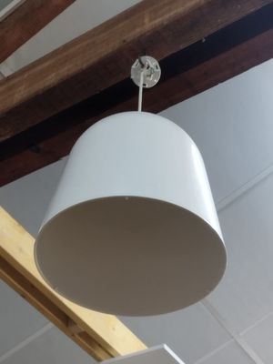 a white lamp hanging from the ceiling in a room
