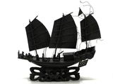 une maquette noire représentant un bateau pirate posée sur une surface blanche