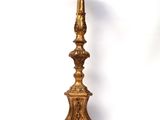 an image of a tall gold candle holder on a white background
