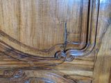 a close up of a wooden door with carvings on it