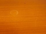 a close up of a wooden table with a clock on it