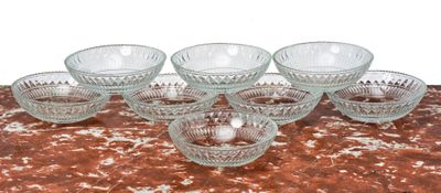 six glass bowls sitting on a table with a red table cloth