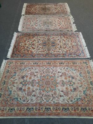 several rugs are laid out on the floor in a room