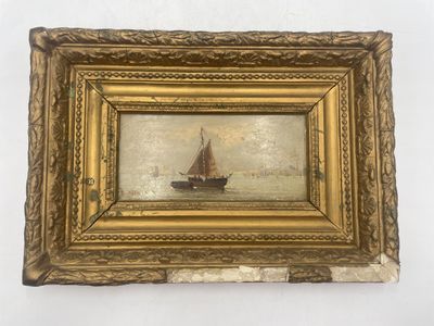 tableau représentant un voilier dans un cadre doré sur fond blanc