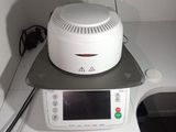 a microwave sitting on top of a table with a clock on it