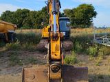 an image of a construction vehicle parked in a field