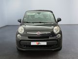 the front of a small black car is parked in a room