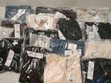 a lot of men ' s clothing in bags on a table