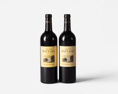two bottles of red wine sitting next to each other on a white surface