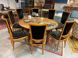 a table and chairs in a room with a rug on the floor