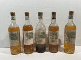 six bottles of alcohol are lined up on a table