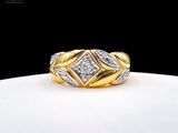 a close up of a gold and diamond ring on a white surface