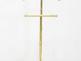 a brass plated coat stand with a coat rack on top of it