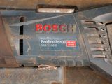 a close up of a bosch drill on a table
