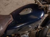 a close up of a motorcycle parked on the side of the road