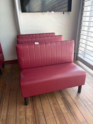 two red chairs in front of a flat screen tv