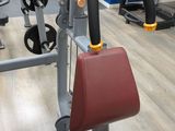 a gym room with a machine and other equipment on the floor