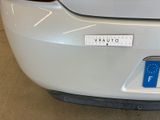 a close up of a car ' s rear bumper with a sticker on it