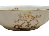 a white bowl with a gold decoration on it
