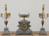 three different types of clocks on a table