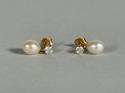 a pair of pearl and diamond earrings