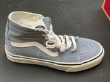 a pair of blue and white shoes sitting on a table