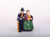 a figurine of a man and a woman sitting on a chair