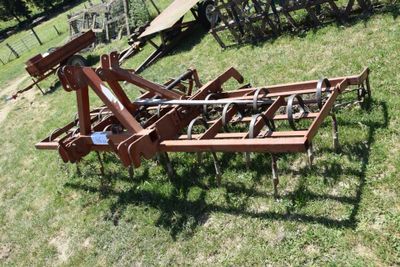 an image of a tractor plow in the grass