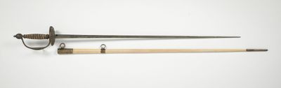 une vieille épée avec un manche en bois sur une surface blanche