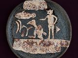 a plate with a picture of a man and a dog on it