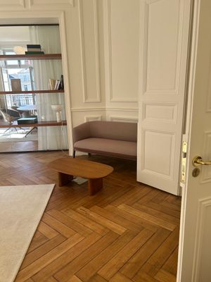 a living room with a couch, coffee table, and bookshelf