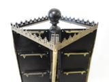 a black and gold cabinet with a black ball on top of it