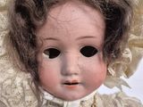 a close up of a doll with a hat on