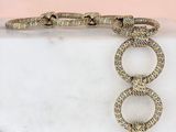 gold tone bracelet with a snake ' s head on top of a white marble block